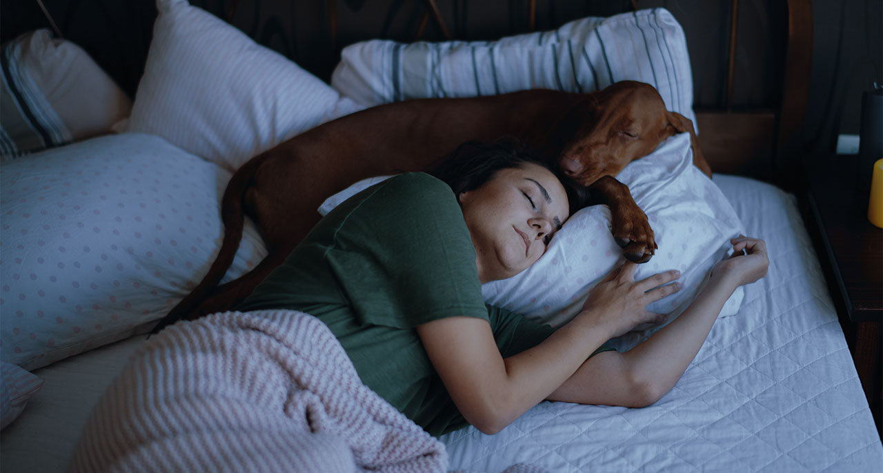 Woman-and-Dog-Sleeping-by-iStockdotcom_Boris-Jovanovic-Cropped.jpg